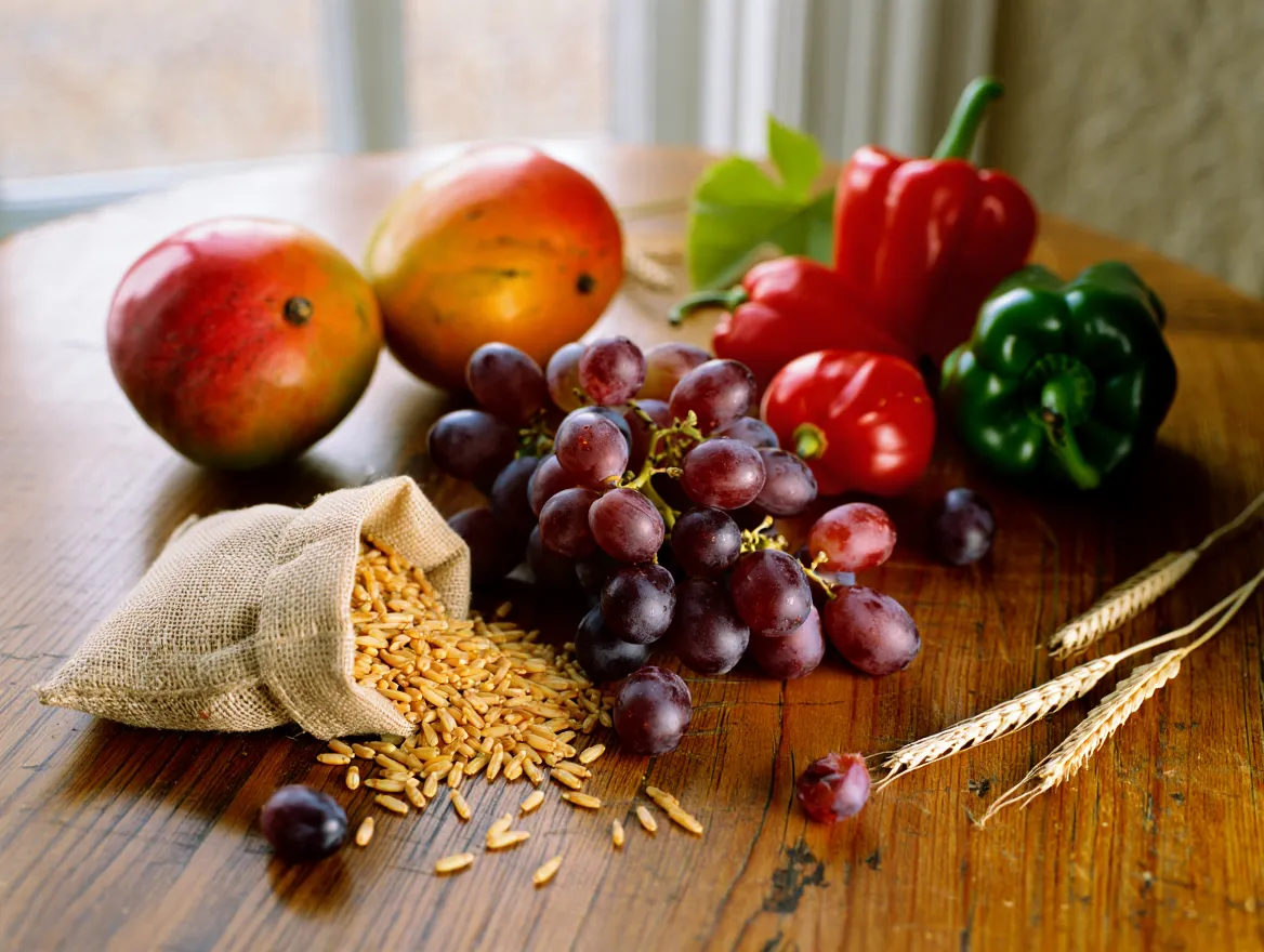 Colorful assortment of fresh fruits, vegetables, and grains arranged on a table